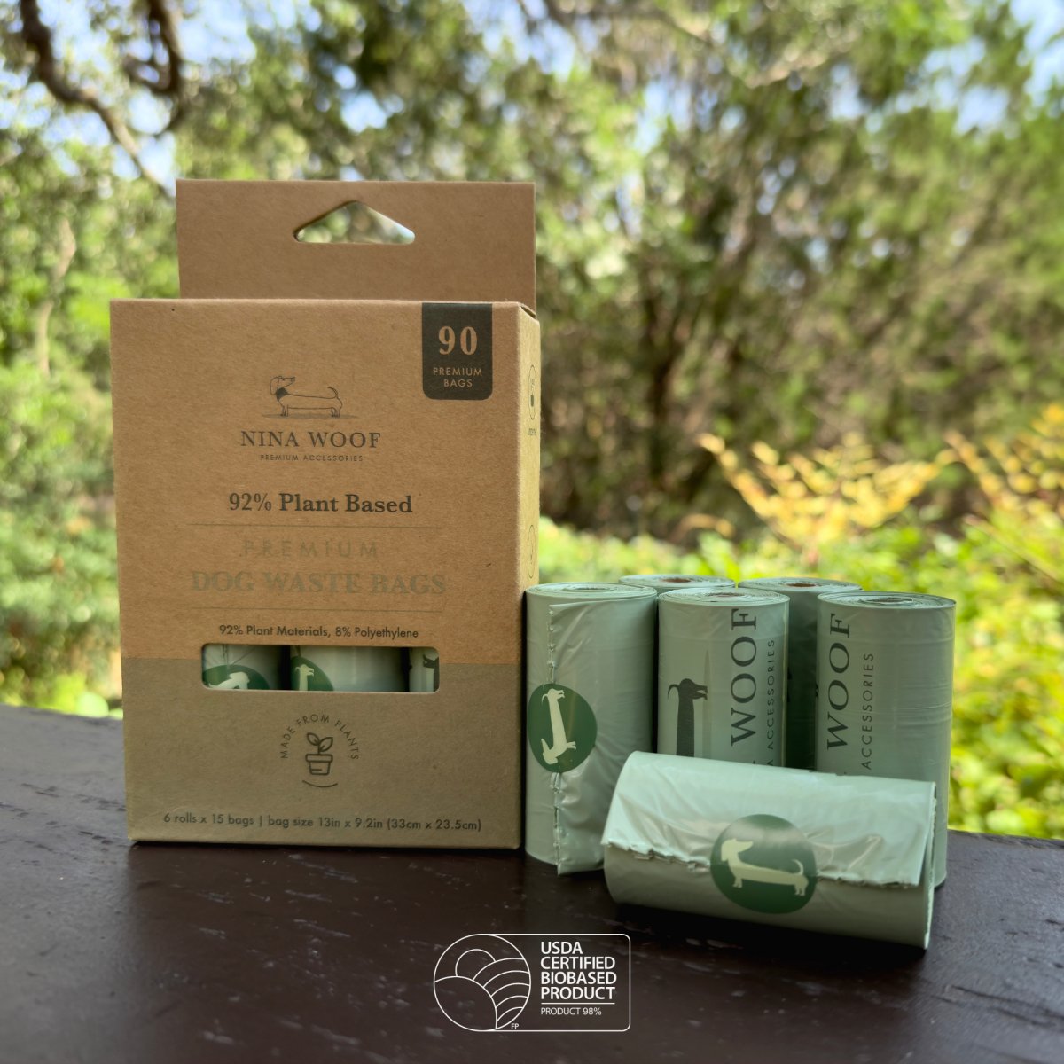 Nina Woof dog waste bags packaging with green bags in the background and a symbol that reflects it is a USDA Certified Biobased Product