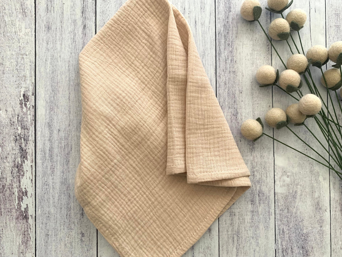 Natural Gauze 100% cotton dinner napkin from Dot and Army, arranged on a wooden surface