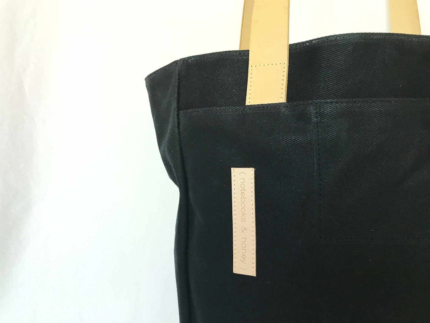Black Waxed Canvas Tote Bag with Royal Blue Nylon Lining – Durable & Stylish - with beige handles on a white background
