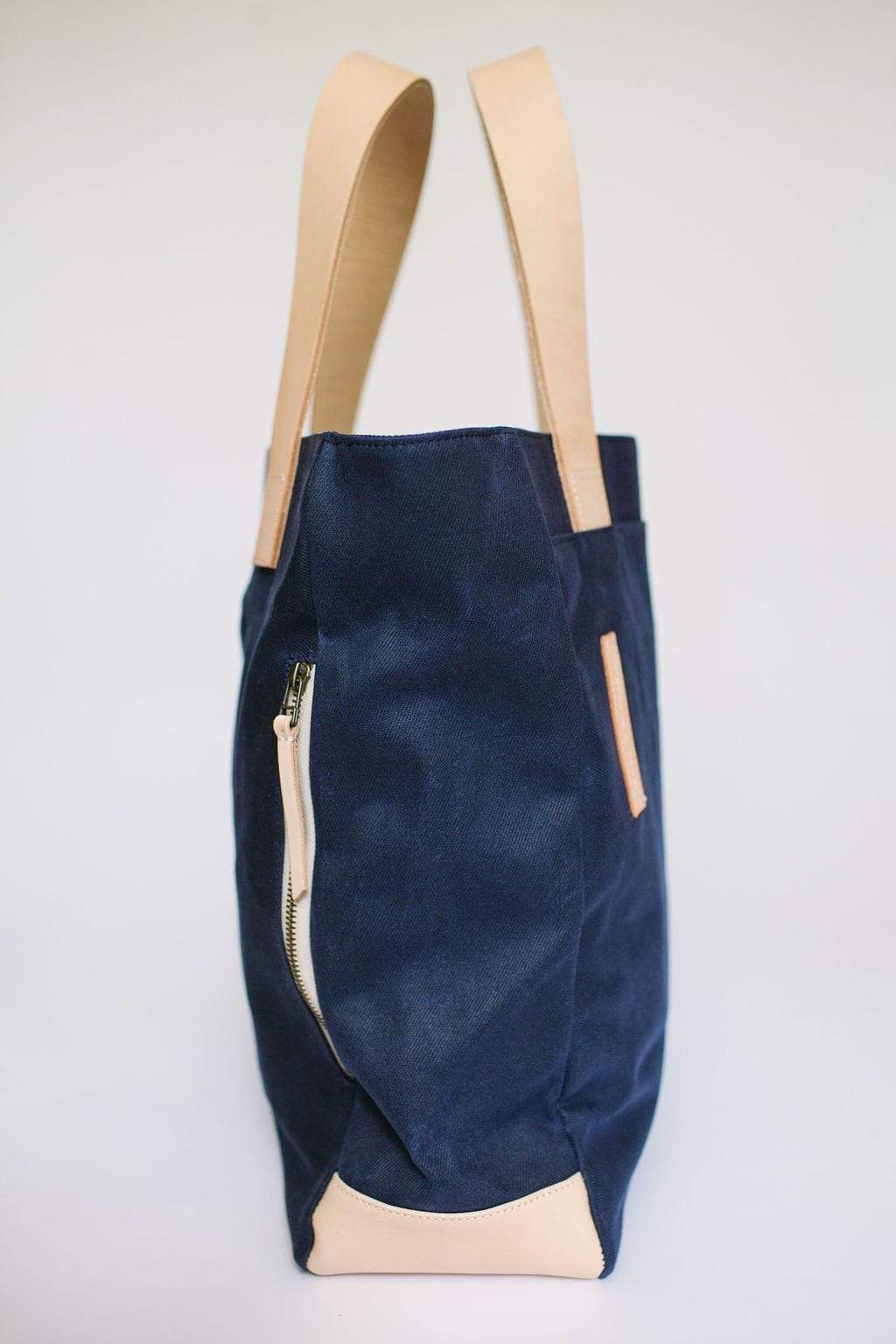 Waxed Canvas Tote Bag – Navy with Bright Pink Lining, Durable & Eco-Friendly with beige handles and trim on a light gray background