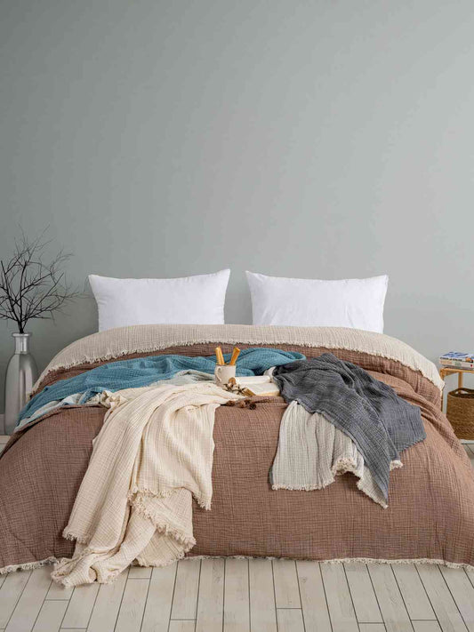 Bed with Premium Turkish Muslin Cotton Blanket – 4-Layer Queen Size in brown with white pillows against a gray wall