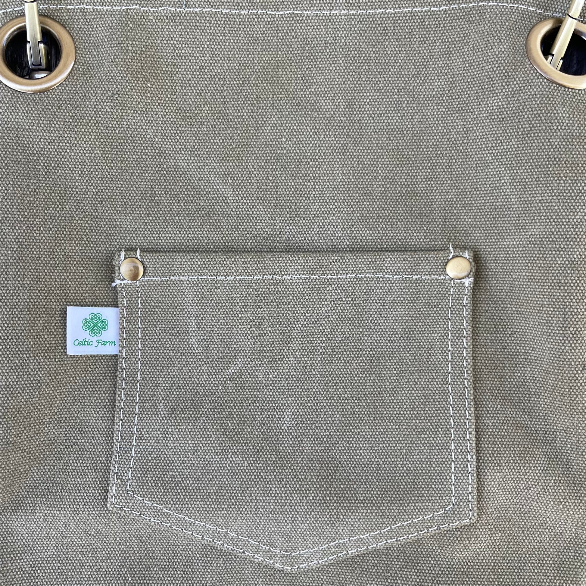 Gray fabric with a pocket and grommets, featuring a visible brand label.
