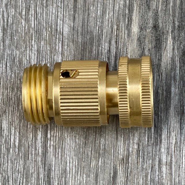 Brass hose fitting on a wooden surface