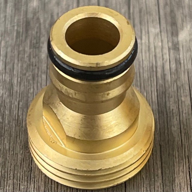 Brass hose fitting on a wooden surface