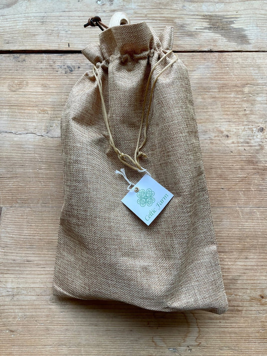 Burlap drawstring bag with a the 5-piece garden master tool set, displayed on a wooden surface
