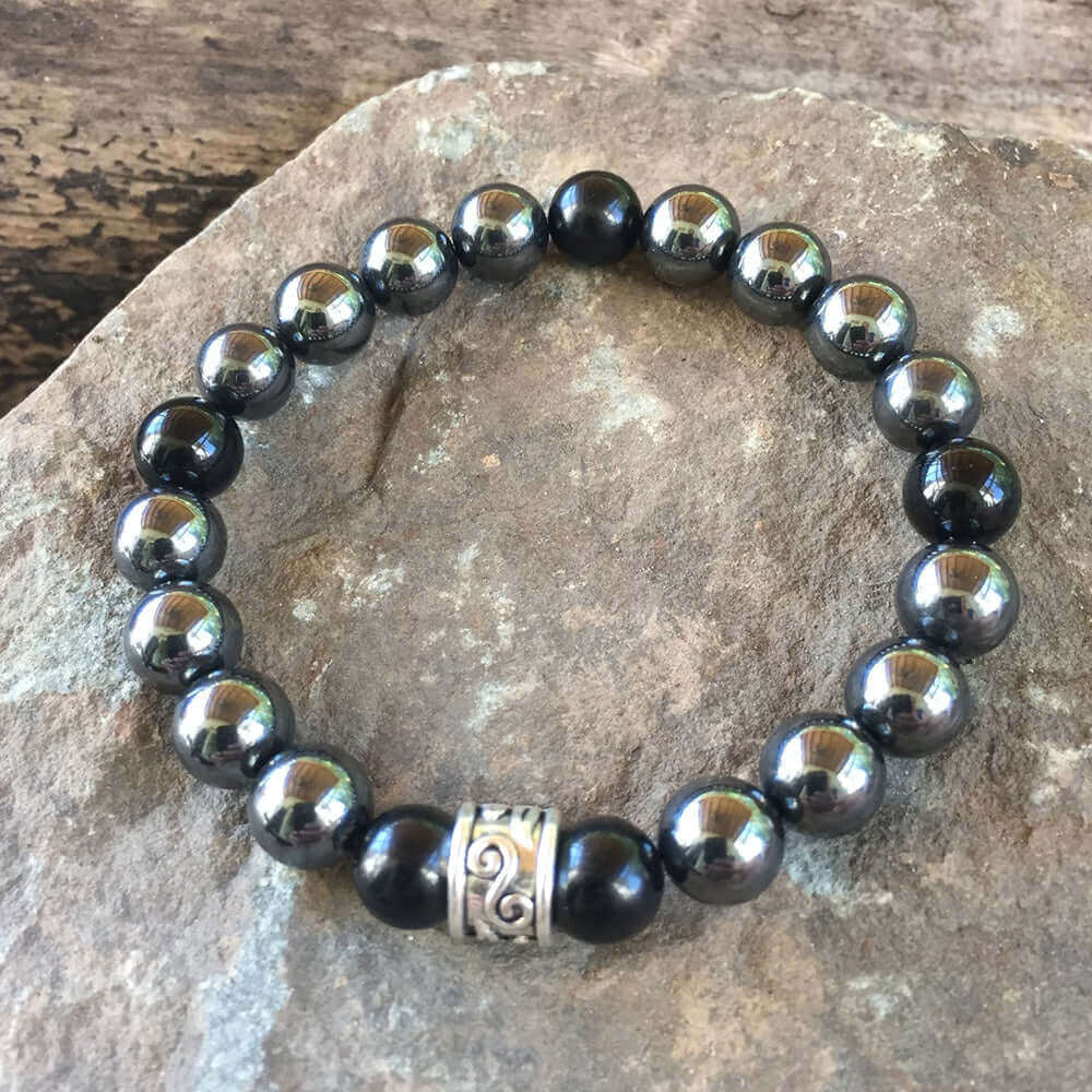 Hematite and Black Obsidian Bead Bracelet This bracelet is made with high-quality Hematite and Black Obsidian stones which bring balance and self-awareness to the wearer. Zodiac Signs: Aquarius, Aries, and Scorpio. Chakras: Root. Handmade with authentic c