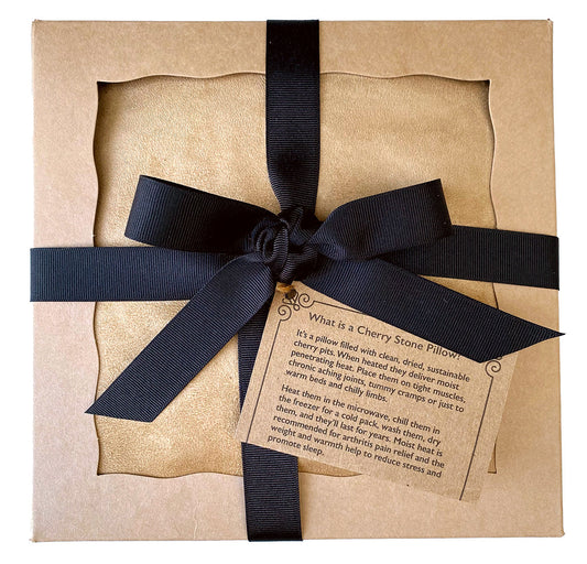 Kraft paper gift box with a black ribbon and product information label on a white background for the Hot Cherry Triple Square Pillow Maraschino Ultra Suede Heating Pad & Cold Pad