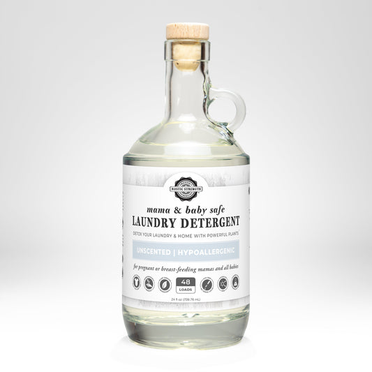 Glass bottle of laundry detergent with a wooden cap on a white background