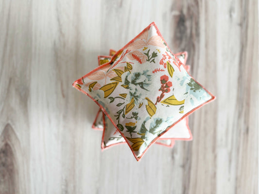 Floral-patterned lavender sachets made of cotton and linen (set of 2) by Dot and Army on a wooden surface