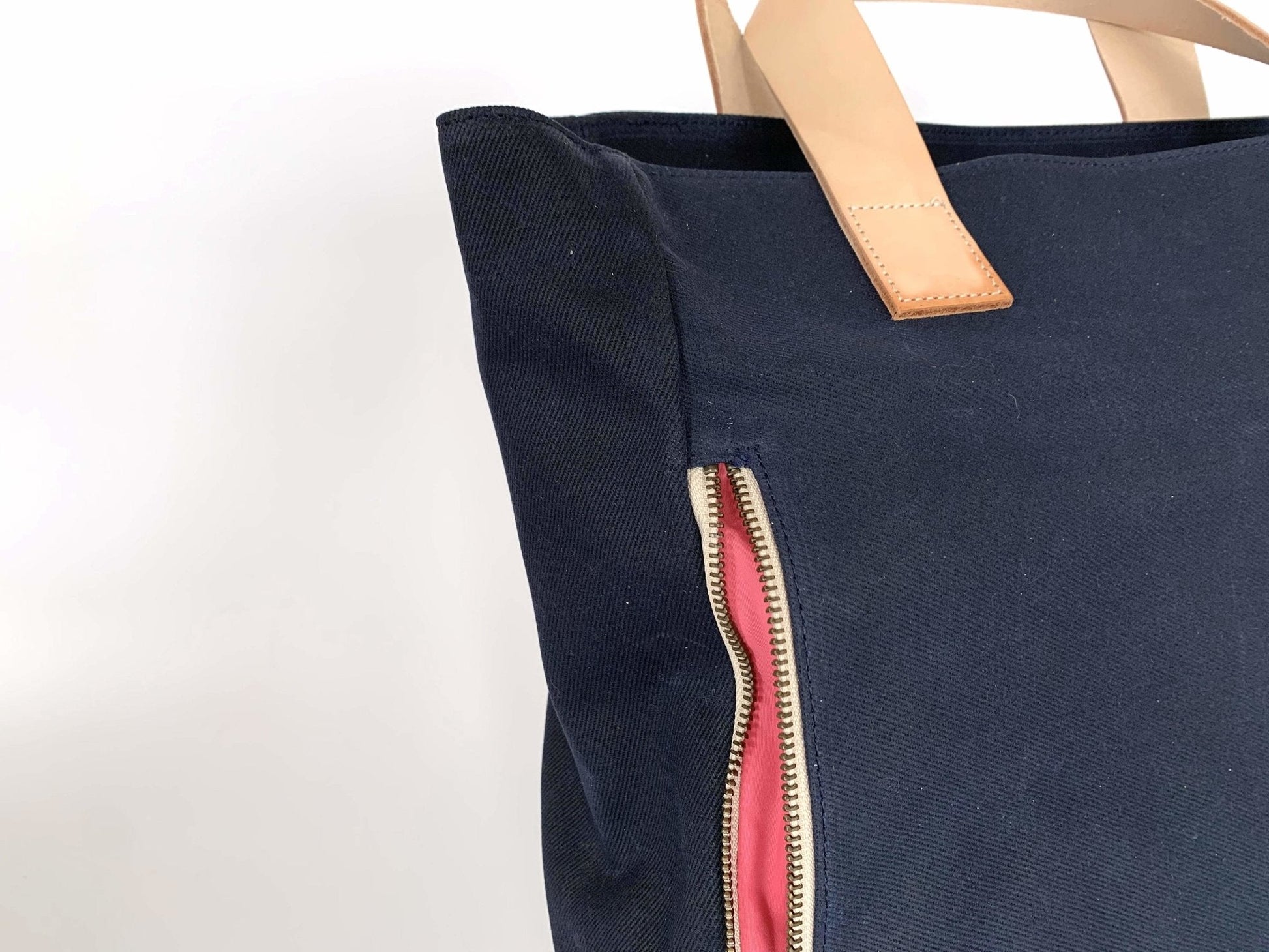 Navy Waxed Canvas Tote Bag – Navy with Bright Pink Lining, Durable & Eco-Friendly, with beige handles and pink interior on a white background