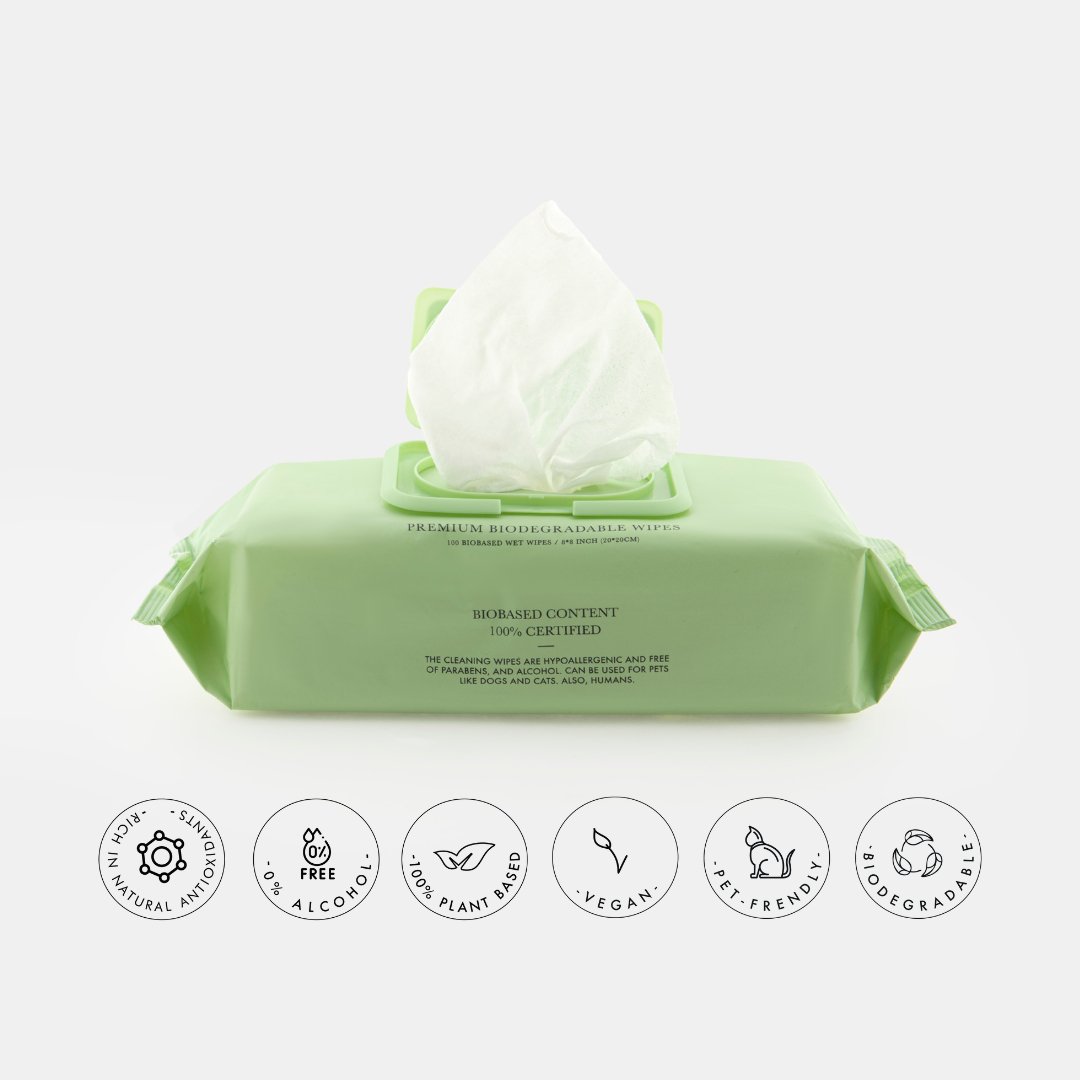Green packaging of Nina Woof premium, vegan, alcohol-free, biodegradable pet wipes with icons indicating product features on a white background