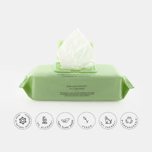 Green packaging of Nina Woof premium, vegan, alcohol-free, biodegradable pet wipes with icons indicating product features on a white background