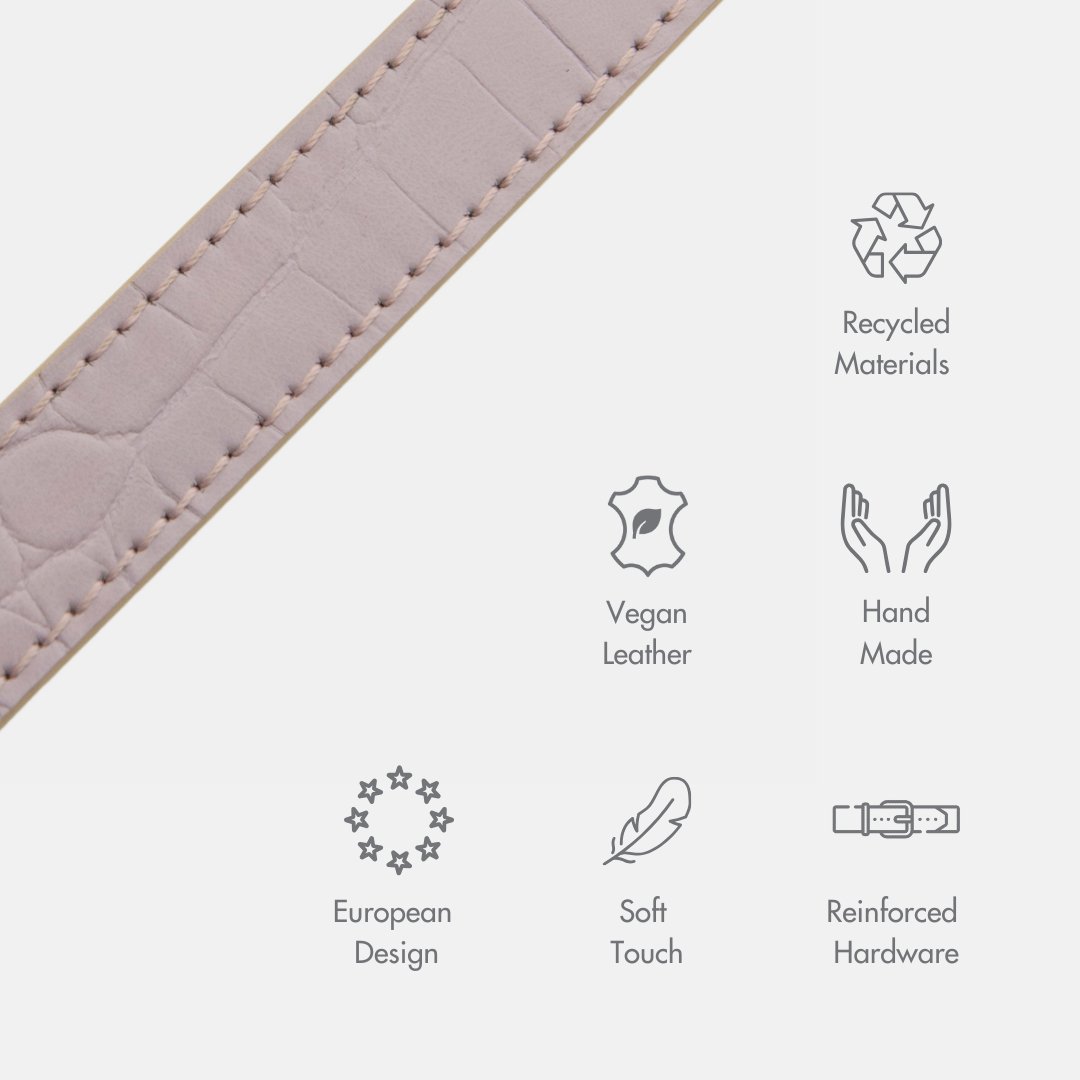 Close-up of a leather product with sustainability icons showcasing the Nina Woof vegan leather dog leash uses recycled materials, is hand made, of European design, has a soft touch and is made with reinforced hardware, shown on a white background.