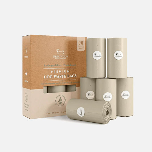 Nina Woof Premium Dog Waste Bags, plant-based and biodegradable, in cardboard, zero-waste packaging with rolls on a white background