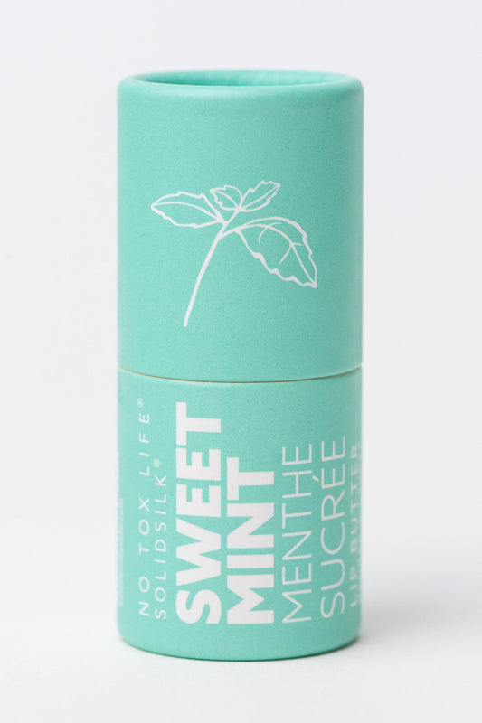 Mint green cylindrical container with No Tox Life Sweet Mint Lip Butter and a plant illustration on a white background.