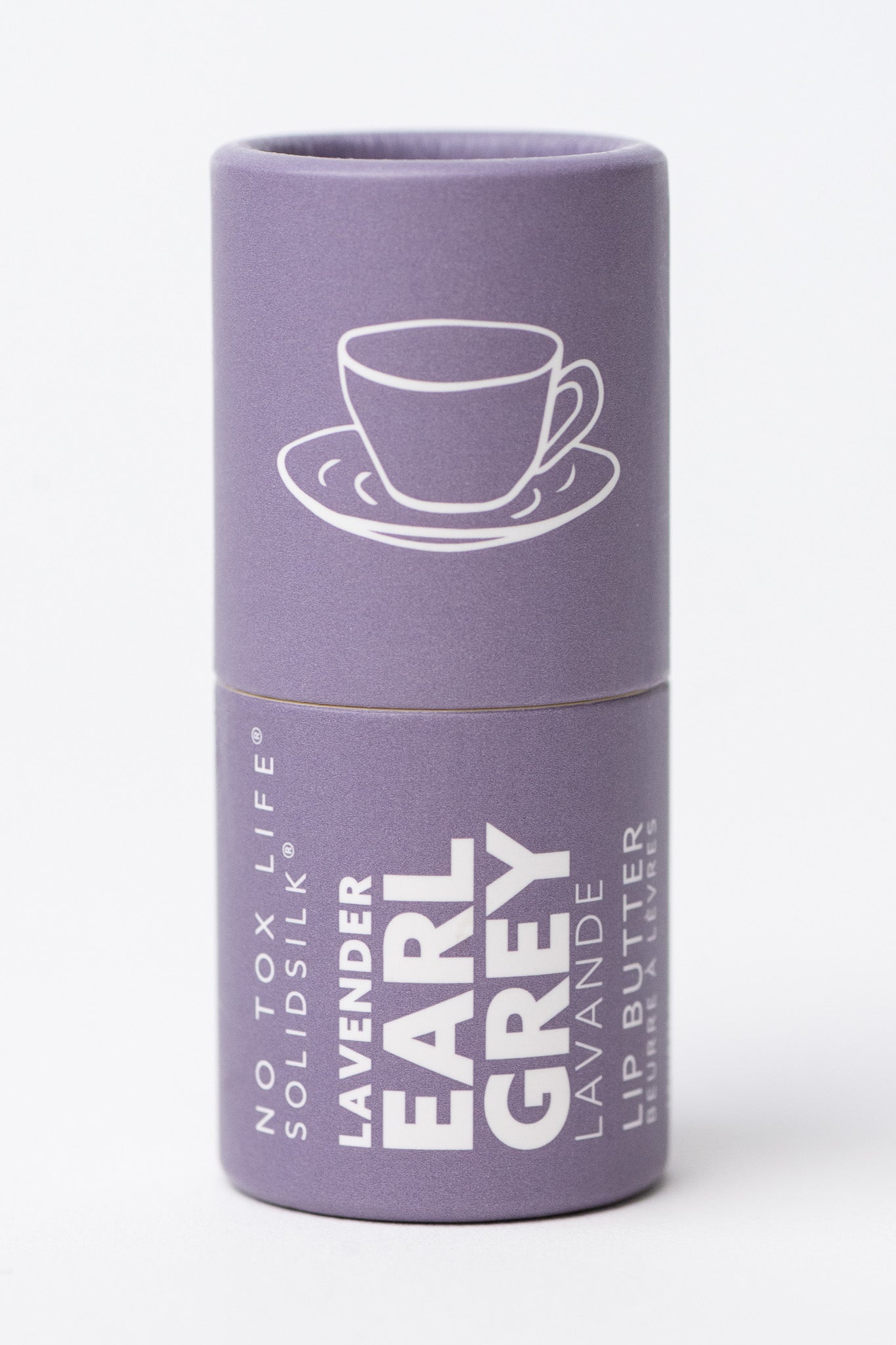No Tox Life SolidSilk Lip Butter in labeled purple paper tube with white labeling and a tea cup illustration on a white background
