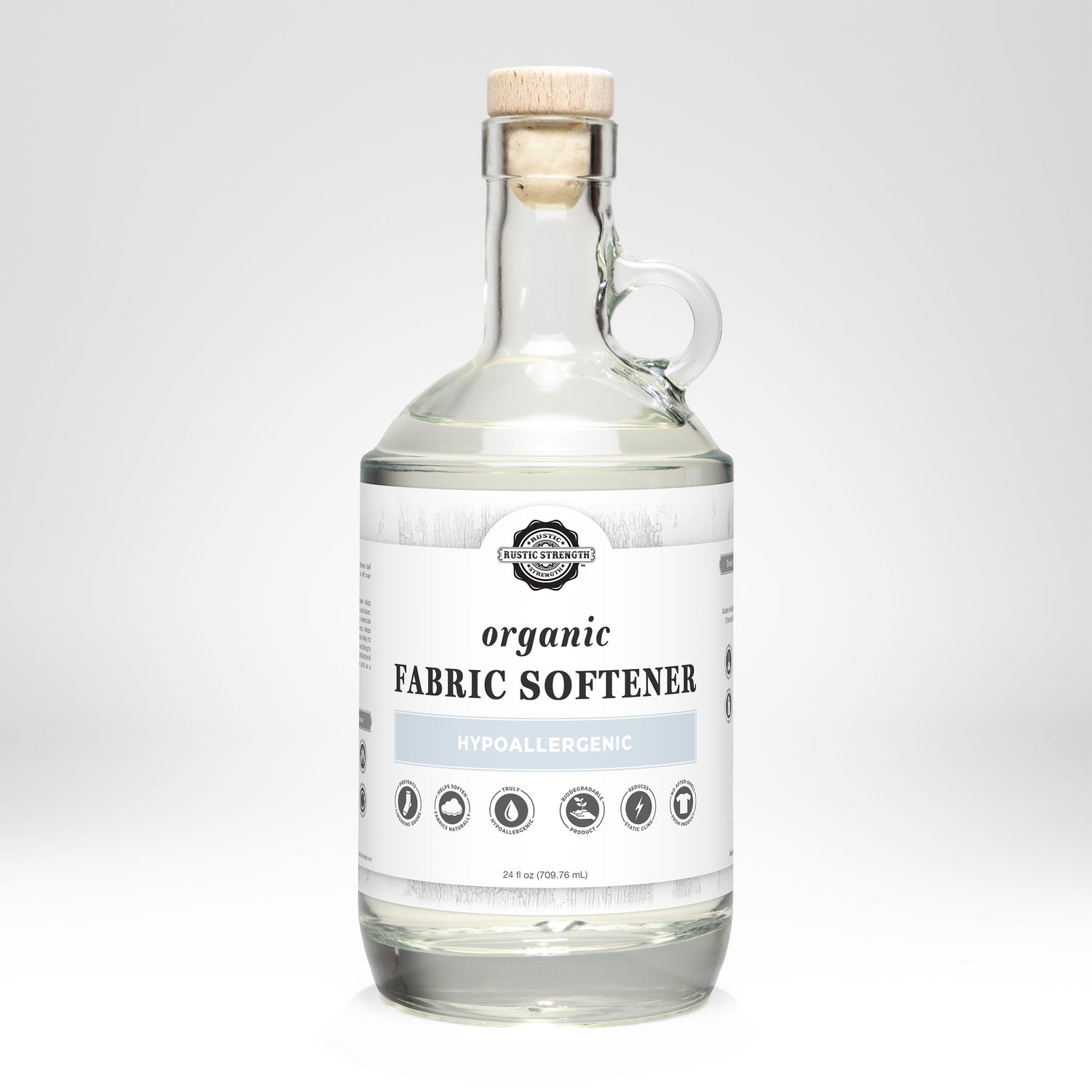 Glass bottle of organic fabric softener on a white background