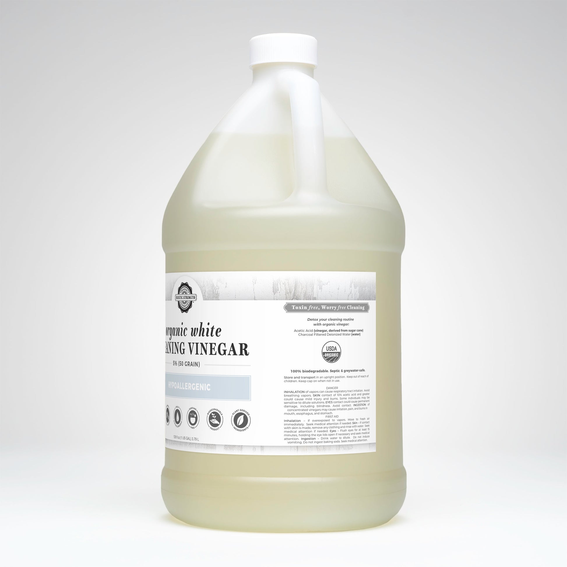Gallon container of organic white cleaning vinegar on a white background