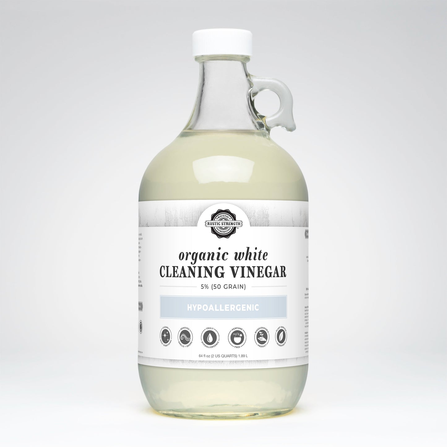 Bottle of organic white cleaning vinegar on a light gray background