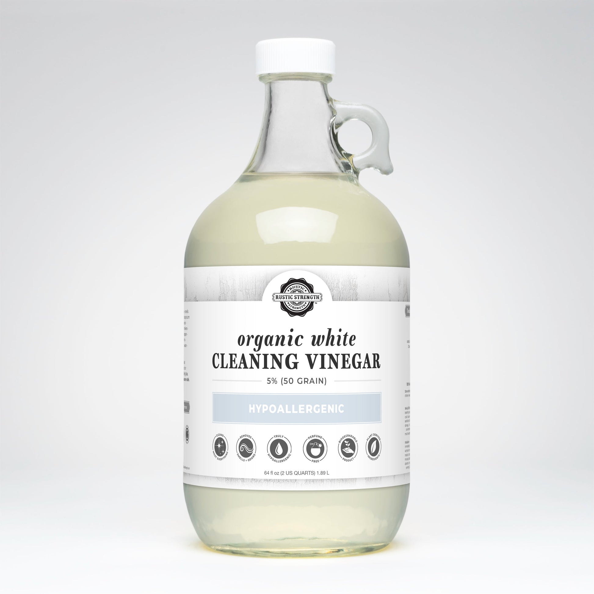 Bottle of organic white cleaning vinegar on a light gray background