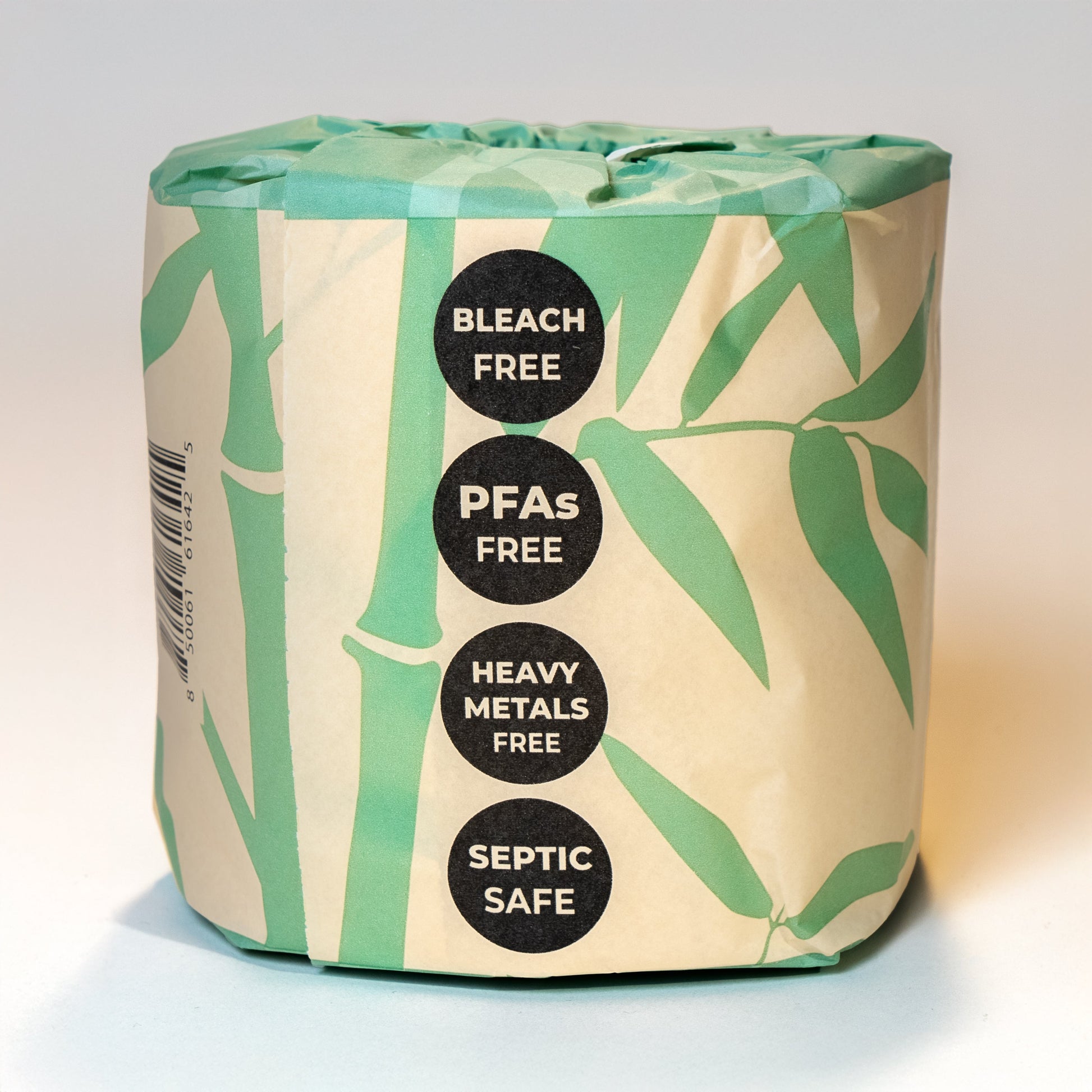 Pack of toilet paper with green leaves on a beige background, featuring text about product safety.