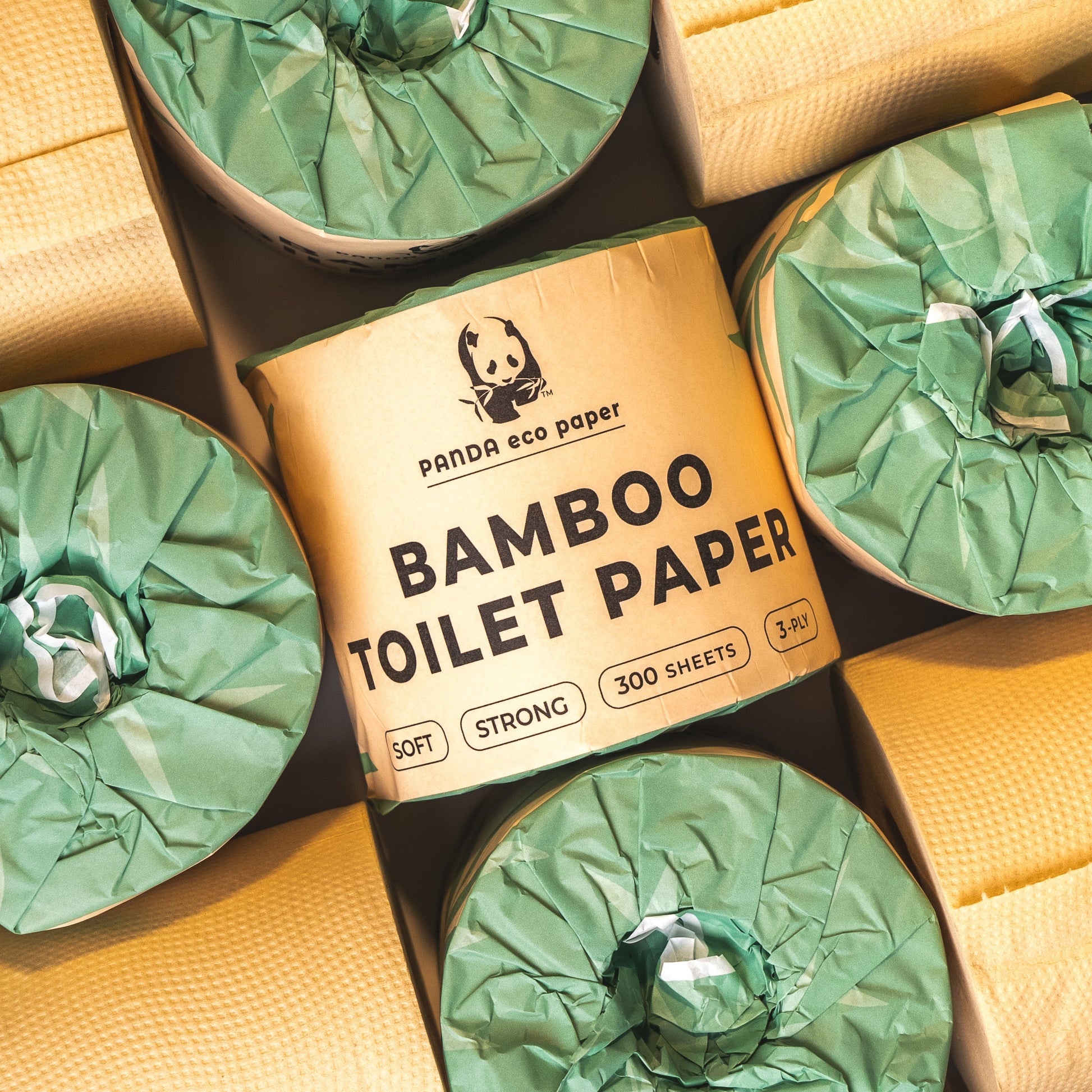 Box of Panda eco paper bamboo toilet paper with green rolls on a yellow background
