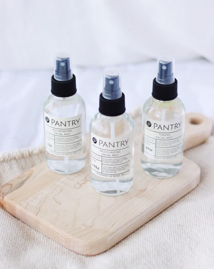 Three glass bottles of Pantry Hydrating Facial Mist made with rosewater and essential oils, including the Rejuvenating Mist, Moisturizing Mist, and Toning Mist sprays.