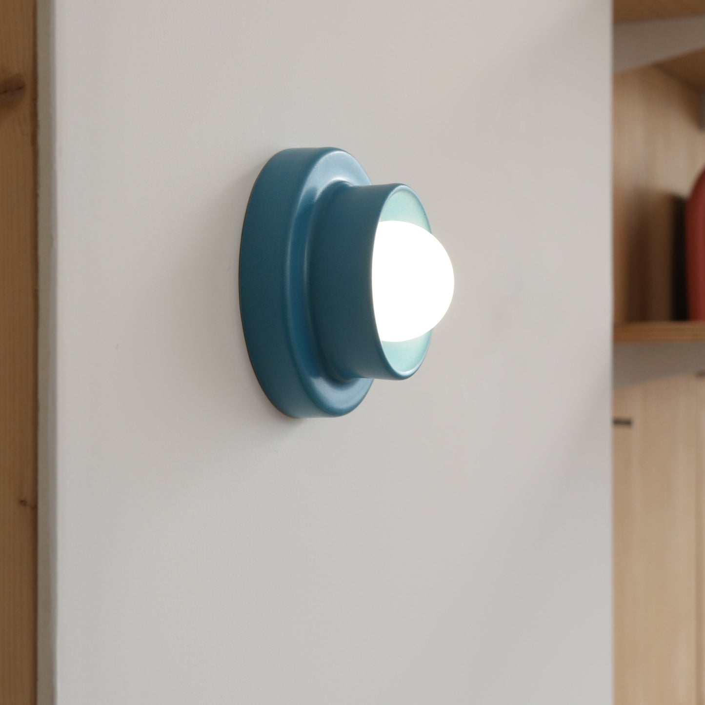 Blue Misewell Q Sconce Handcrafted Ceramic Wall Light on a white wall