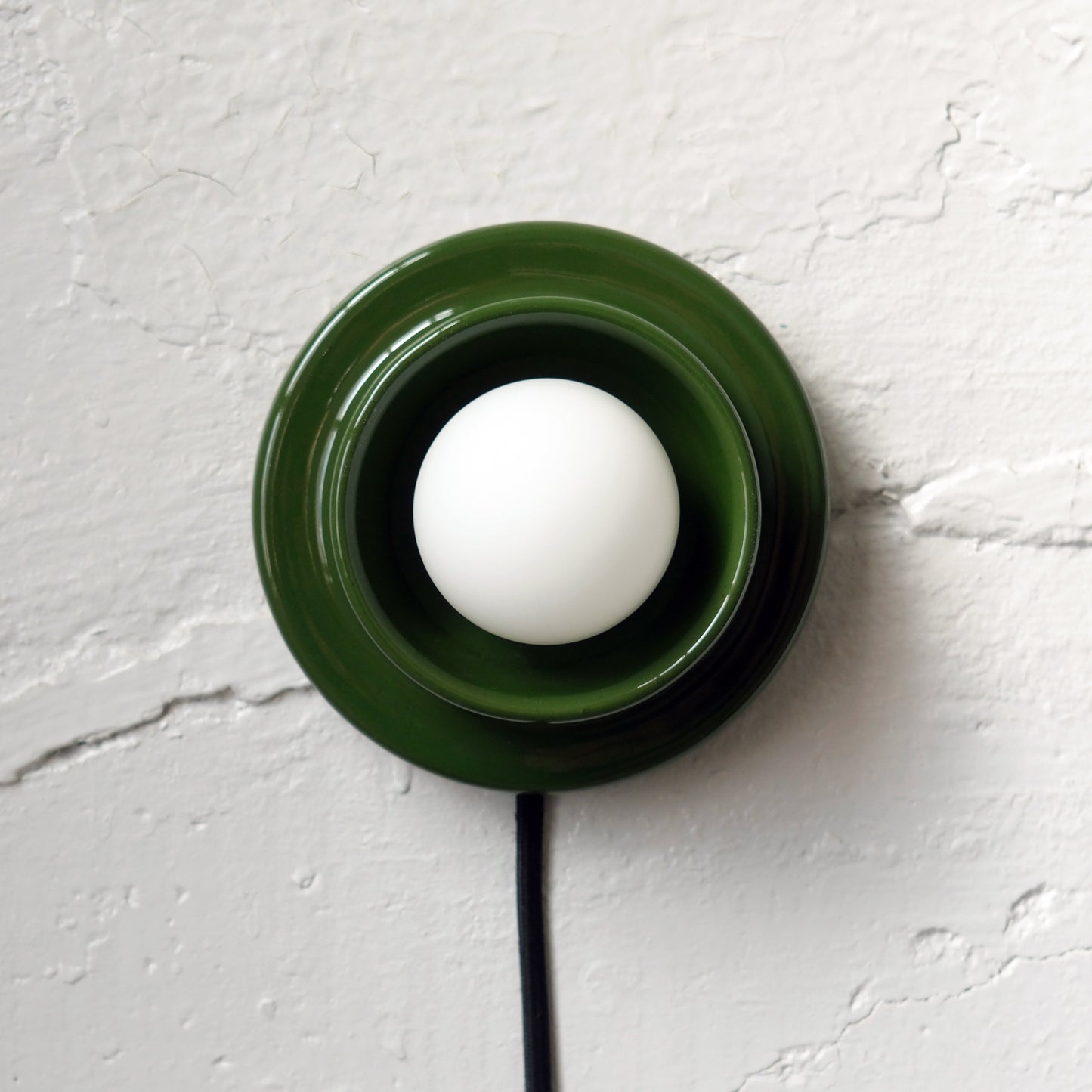 Green Misewell Q Sconce Handcrafted Ceramic Wall Light on a white wall