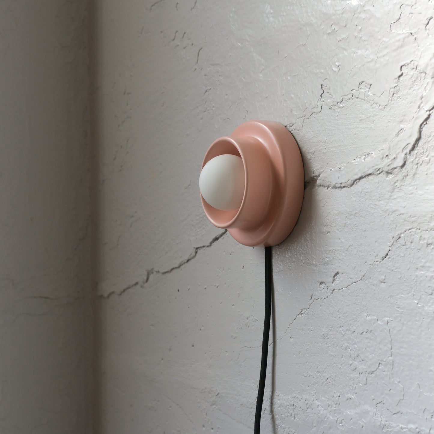 Pink Misewell Q Sconce Handcrafted Ceramic Wall Light on a white wall
