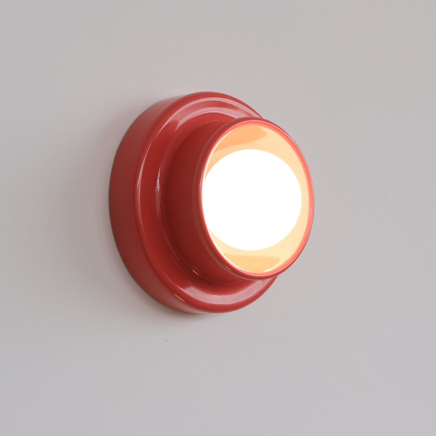 Vermillion Misewell Q Sconce Handcrafted Ceramic Wall Light on a white wall