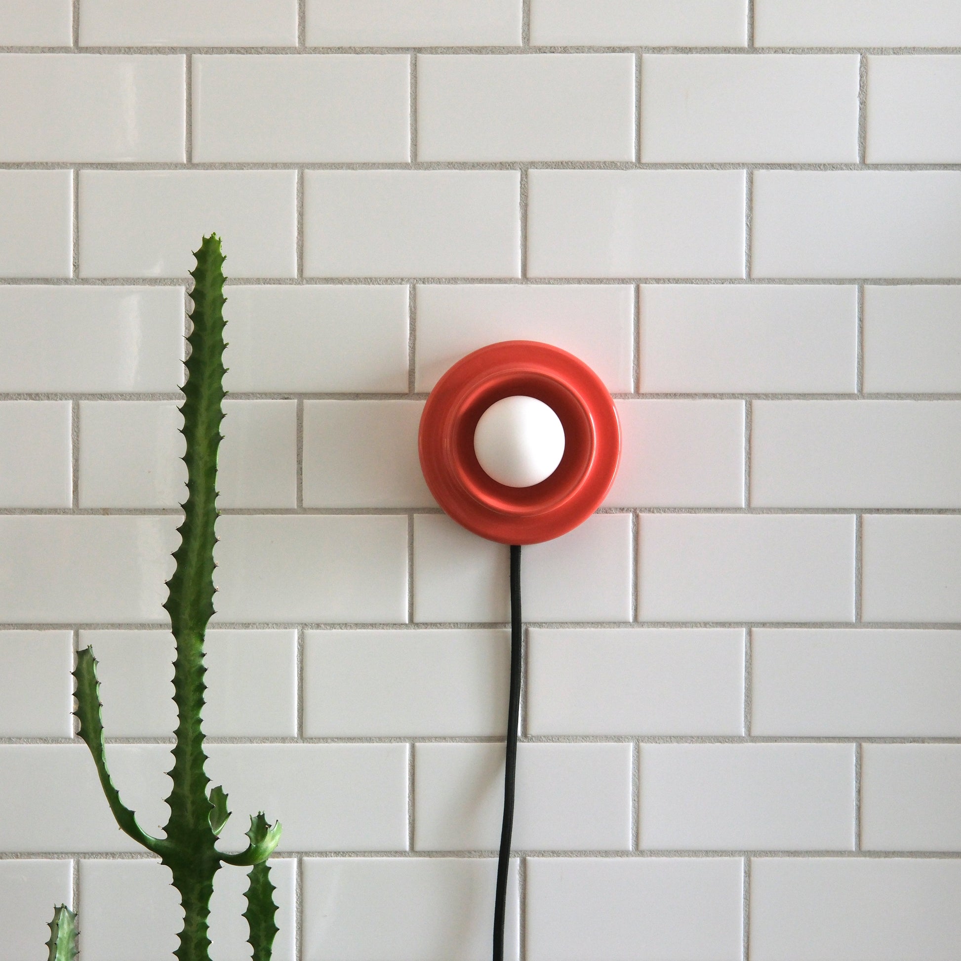Vermillion Misewell Q Sconce Handcrafted Ceramic Wall Light on a white wall