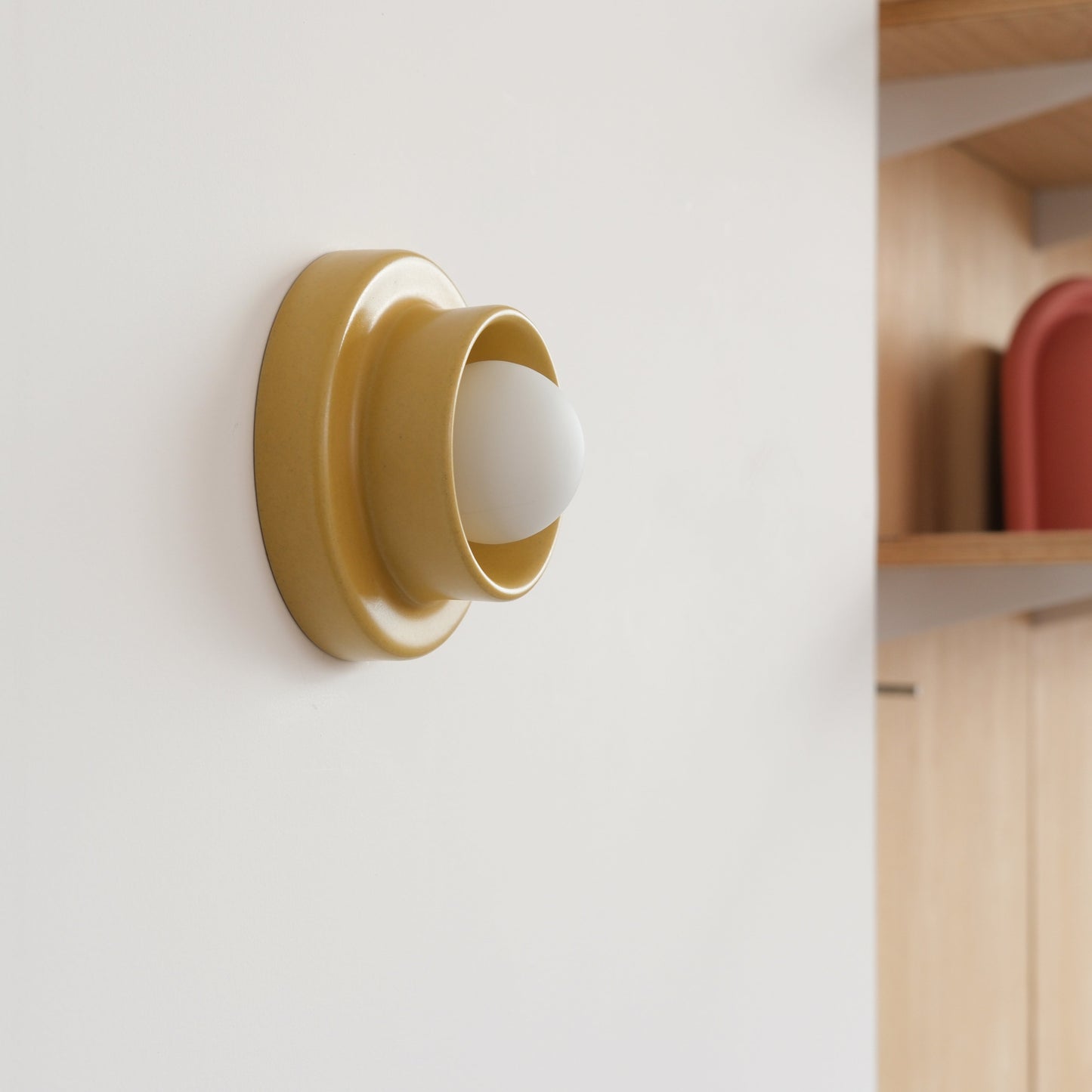 Yellow Misewell Q Sconce Handcrafted Ceramic Wall Light on a white wall