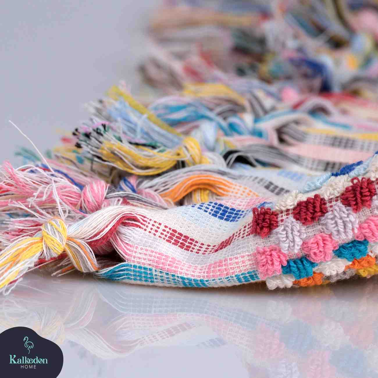 Rainbow Premium Organic Turkish Jacquard Bath Towel on a reflective surface with 'Kalkedon' branding.