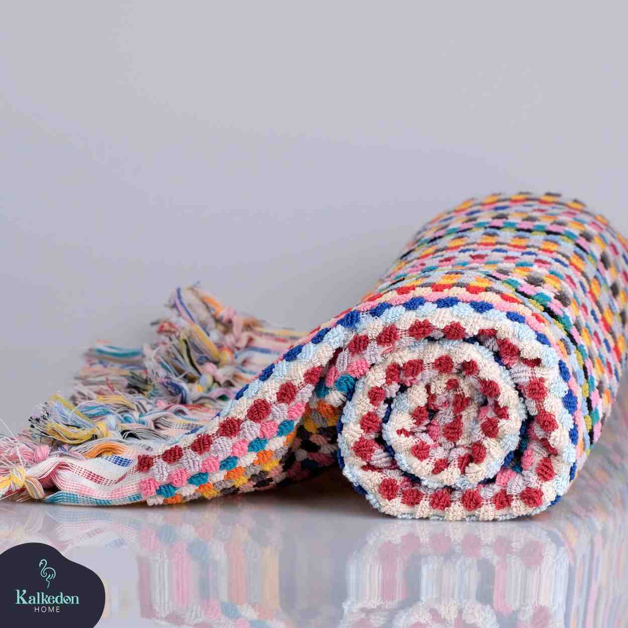 Rolled-up rainbow Premium Organic Turkish Jacquard Bath Towel – Oversized & Plush with a Kalkedon brand logo in the corner