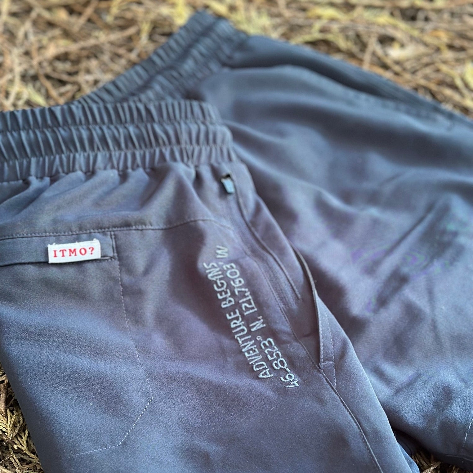 Athletic 5 Inch Recycled Shorts in Deep Navy by Rainier Watch with text and a label on a textured surface