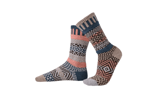 Pair of patterned, recycled merino wool blend crew socks by Solmate on a transparent background