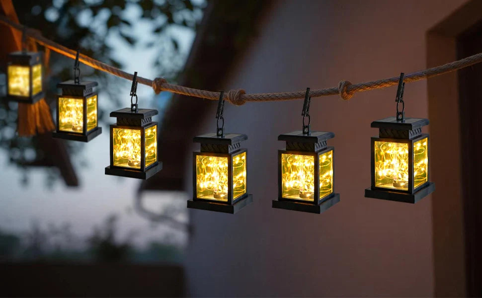 String of solar lanterns hanging on a rope against a blurred background