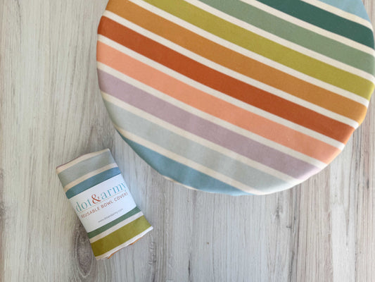 Colorful striped Reusable Cotton Bowl Cover by Dot & Army on a wooden surface