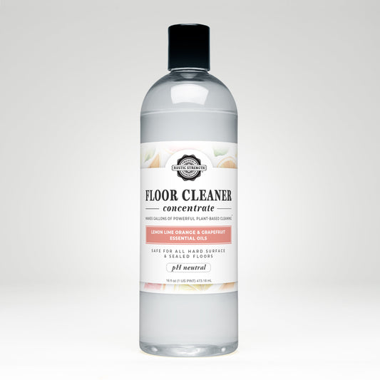 Bottle of Rustic Strength floor cleaner concentrate with a label on a white background