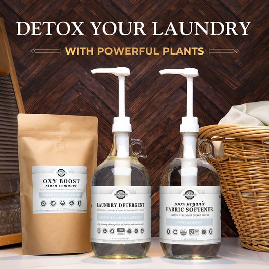 Three laundry products with packaging labeled 'Oxy Boost', 'Laundry Detergent', and 'Fabric Softener' on a wooden surface.