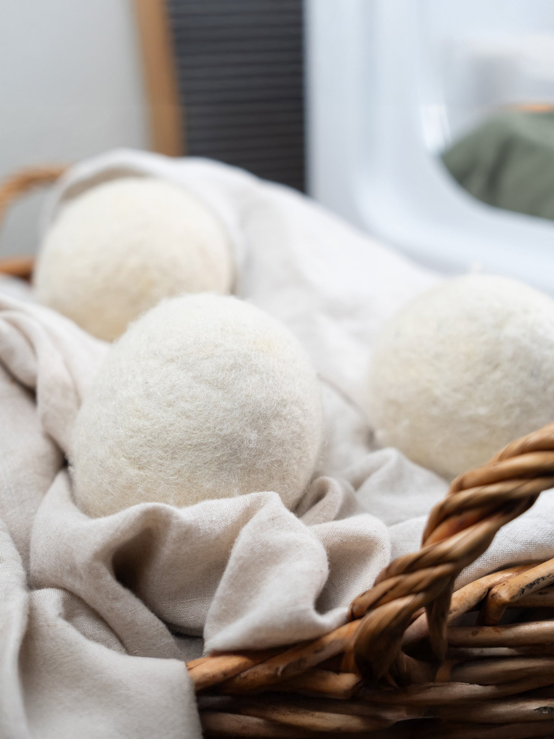 White laundry detergent balls in a wicker basket with fabric