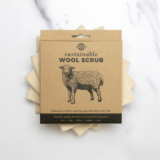 Packaged sustainable wool scrub with a sheep illustration on a white background