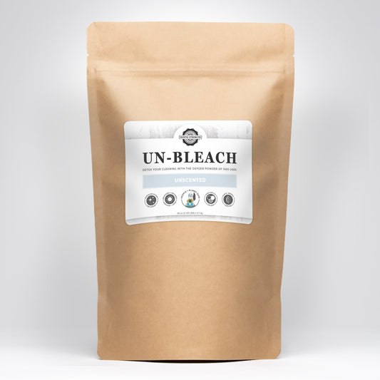 Brown paper bag containing a white Rustic Strength Un-Bleach label