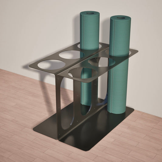 Yoke black metal stand holding two green yoga mats of six available slots on a wooden floor.