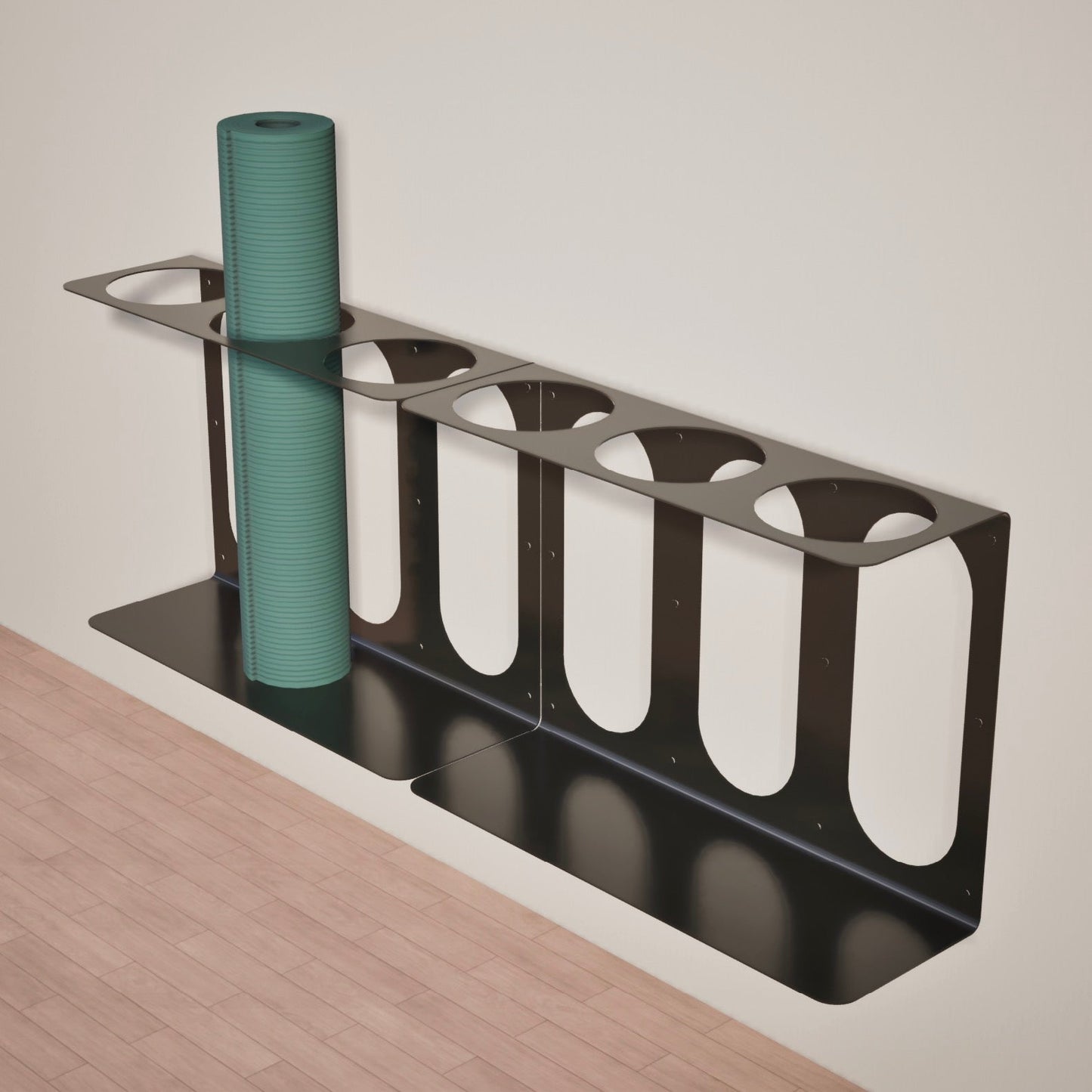 Two black Yoke yoga mat wall brackets mounted side-by-side with one green yoga mat in the 6 available slots, displayed on a wooden floor and light gray wall background